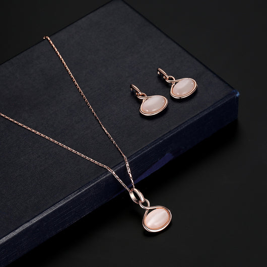Rose gold necklace and matching drop earrings set with oval light pink cabochon stones. - Image 5