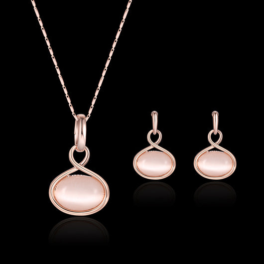 Rose gold necklace and matching drop earrings set with oval light pink cabochon stones. - Image 2