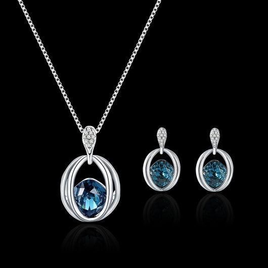 Silver-tone necklace and drop earrings set with blue cushion-cut crystals and clear accents, ideal for bridal wear.