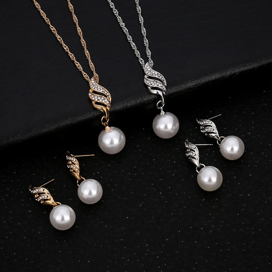 Gold-toned necklace and earring set with white faux pearls and clear rhinestones in a wavy design. - Image 3