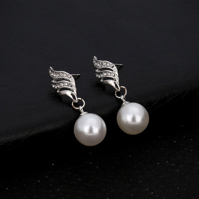 Gold-toned necklace and earring set with white faux pearls and clear rhinestones in a wavy design. - Image 5