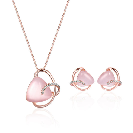 Rose gold-toned necklace and stud earrings set with triangular pink stones and clear rhinestone accents. - Image 2
