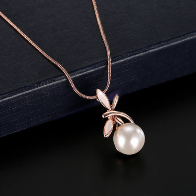 Rose gold-toned necklace and matching earrings set with white pearls and a delicate floral or leaf design. - Image 5