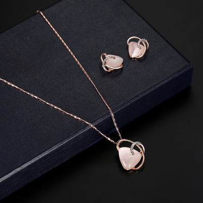 Rose gold-toned necklace and stud earrings set with triangular pink stones and clear rhinestone accents. - Image 4
