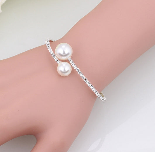 Elegant silver-tone choker necklace with a single row of clear rhinestones and two white faux pearls of varying sizes. - Image 4