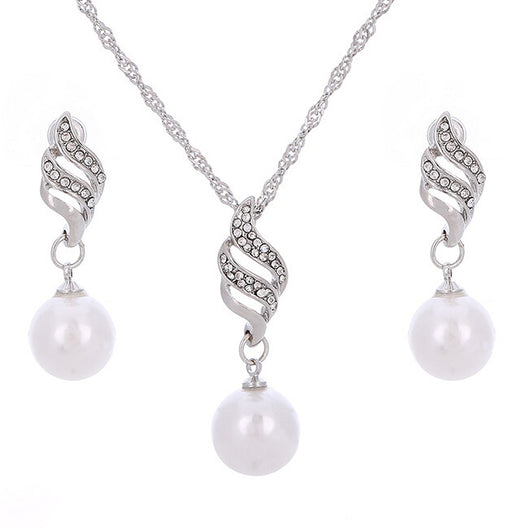 Gold-toned necklace and earring set with white faux pearls and clear rhinestones in a wavy design. - Image 2