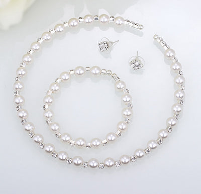 Bridal three-piece jewelry set with white pearls and clear rhinestones, including a necklace, bracelet, and square stud earrings. - Image 4