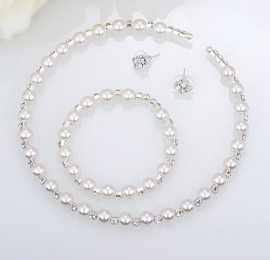 Bridal three-piece jewelry set with white pearls and clear rhinestones, including a necklace, bracelet, and square stud earrings. - Image 4