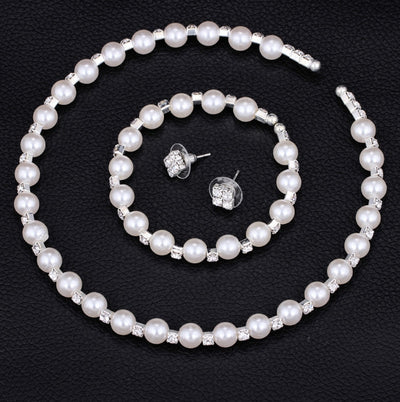 Bridal three-piece jewelry set with white pearls and clear rhinestones, including a necklace, bracelet, and square stud earrings. - Image 2