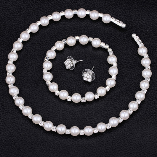 Bridal three-piece jewelry set with white pearls and clear rhinestones, including a necklace, bracelet, and square stud earrings. - Image 2