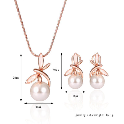 Rose gold-toned necklace and matching earrings set with white pearls and a delicate floral or leaf design. - Image 3