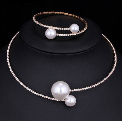 Elegant silver-tone choker necklace with a single row of clear rhinestones and two white faux pearls of varying sizes. - Image 3