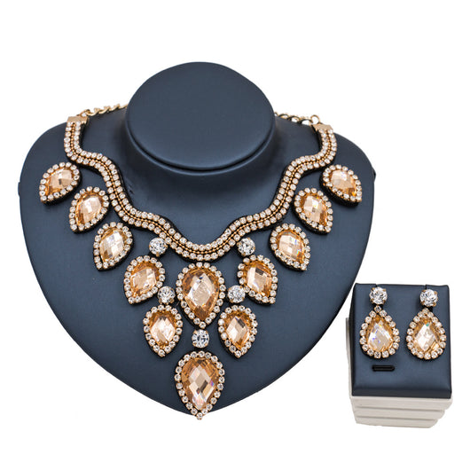 Colorful exaggerated bride necklace and earring set with large teardrop rhinestones on a dark display. - Image 5