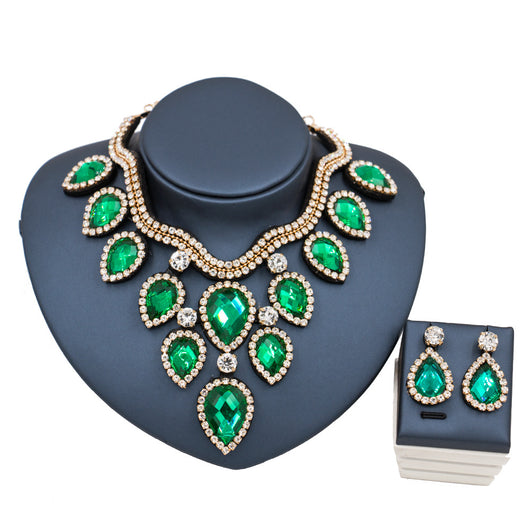 Colorful exaggerated bride necklace and earring set with large teardrop rhinestones on a dark display. - Image 8
