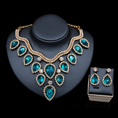 Colorful exaggerated bride necklace and earring set with large teardrop rhinestones on a dark display. - Image 16