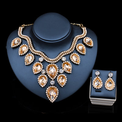 Colorful exaggerated bride necklace and earring set with large teardrop rhinestones on a dark display. - Image 15