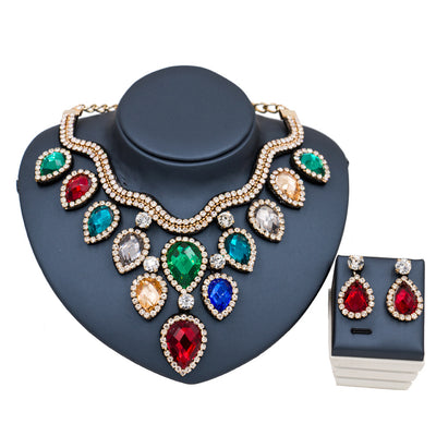 Colorful exaggerated bride necklace and earring set with large teardrop rhinestones on a dark display. - Image 6