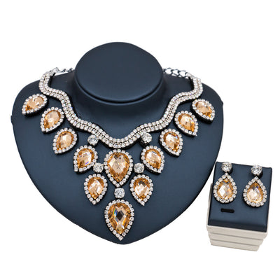 Colorful exaggerated bride necklace and earring set with large teardrop rhinestones on a dark display. - Image 9