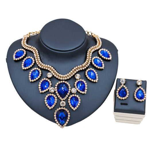 Colorful exaggerated bride necklace and earring set with large teardrop rhinestones on a dark display. - Image 4