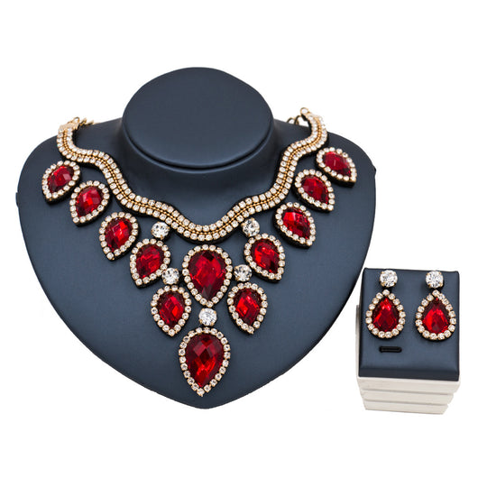 Colorful exaggerated bride necklace and earring set with large teardrop rhinestones on a dark display. - Image 7