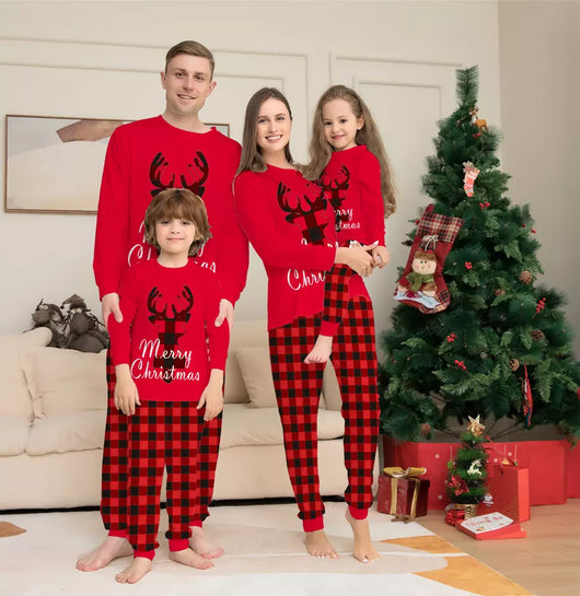 Family of four wearing matching red and black buffalo plaid Christmas pajamas with reindeer and "Merry Christmas" text. - Image 2