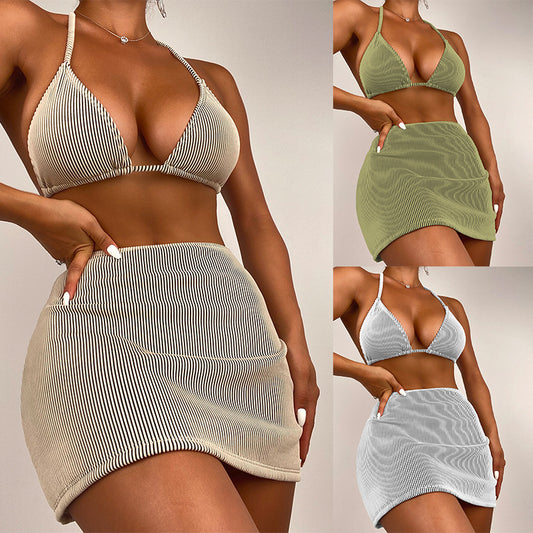 Light green ribbed bikini set featuring a triangle halter top and a matching high-waisted mini skirt.
