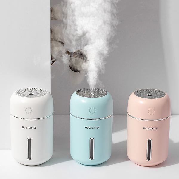 Pink USB car humidifier with a cylindrical design, silver accents, and a clear water level indicator.