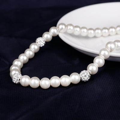 White faux pearl necklace, bracelet, and dangle earrings set with pave crystal beads on a black display. - Image 2