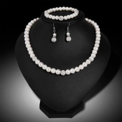 White faux pearl necklace, bracelet, and dangle earrings set with pave crystal beads on a black display. - Image 6