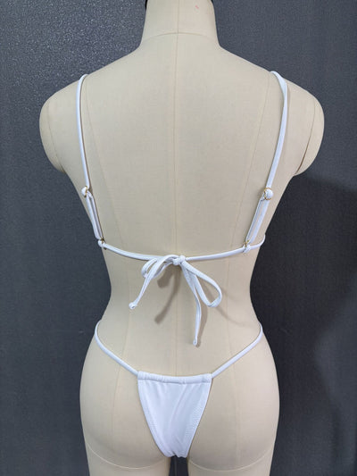 White three-point bikini with gold chain straps on a mannequin, featuring a triangle top and thong bottom. - Image 21