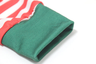 Family of six wearing matching red and white striped long-sleeved pajamas with green cuffs and festive hats. - Image 8