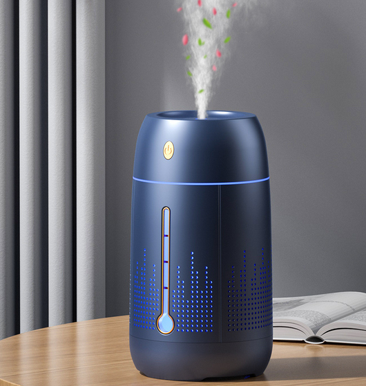White cylindrical household humidifier with a visible water level indicator, next to its brown cardboard packaging. - Image 16