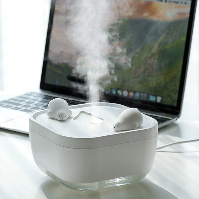 White ultrasonic humidifier with a clear base and a cute polar bear figurine on top, emitting a fine mist. - Image 2