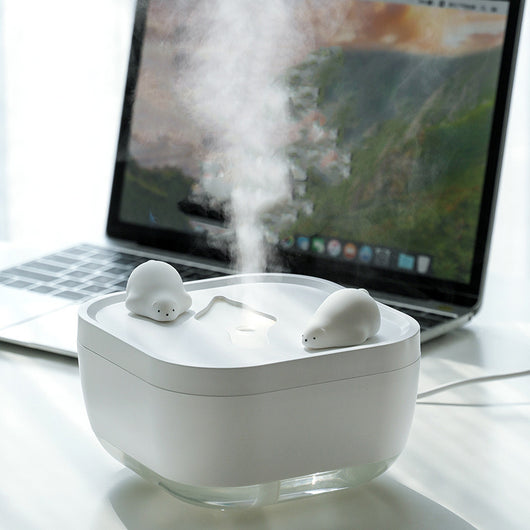 White ultrasonic humidifier with a clear base and a cute polar bear figurine on top, emitting a fine mist. - Image 2