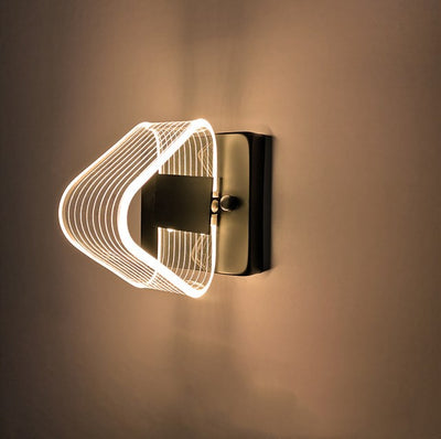 Modern simple LED wall lamp with a curved clear acrylic shade and a metallic base, emitting a warm light. - Image 9