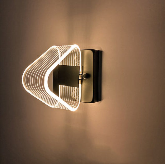 Modern simple LED wall lamp with a curved clear acrylic shade and a metallic base, emitting a warm light. - Image 9