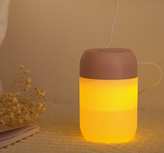 White cylindrical mini humidifier with a soft yellow glow, suitable for air moisturizing and aromatherapy, USB powered. - Image 10