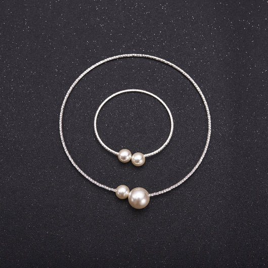 Elegant silver-tone choker necklace with a single row of clear rhinestones and two white faux pearls of varying sizes. - Image 2