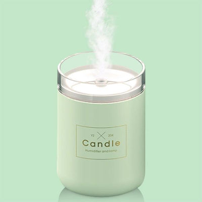 Light pink mini USB humidifier diffuser, shaped like a candle, with a clear top and visible mist output. - Image 11
