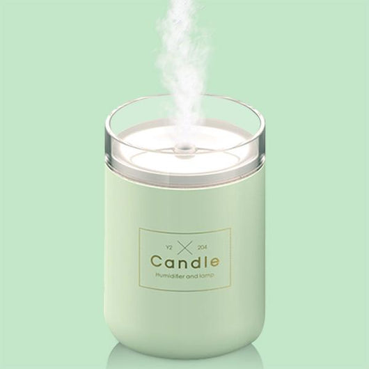 Light pink mini USB humidifier diffuser, shaped like a candle, with a clear top and visible mist output. - Image 11