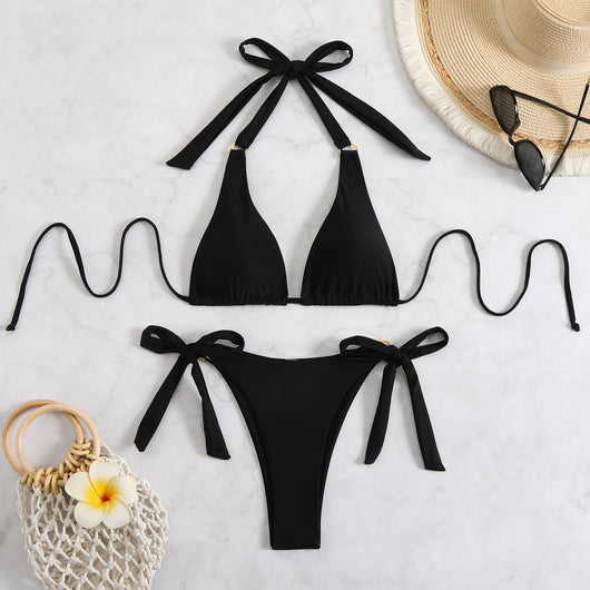 Black two-piece swimsuit with a halter triangle top and high-cut tie-side bottoms featuring gold-tone rings. - Image 17