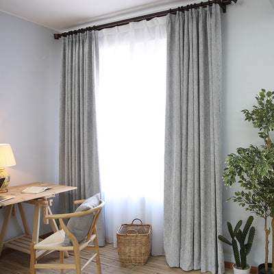 Close-up of a solid teal blue curtain fabric with a thick, visible woven texture, suitable for modern decor.