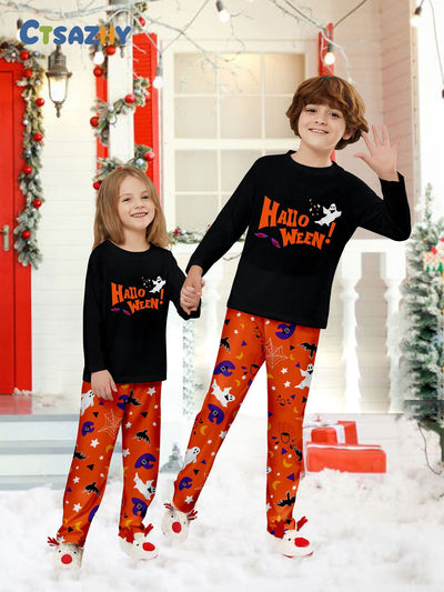 Family of four wearing matching black and orange Halloween long-sleeve pajamas with ghost and bat prints. - Image 17