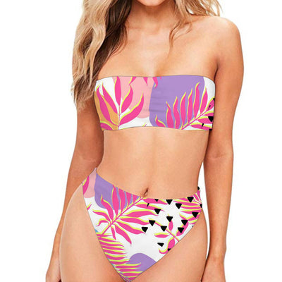 Dark blue two-piece bikini with strapless bandeau top and high-waisted bottom, featuring a tropical leaf and floral print.