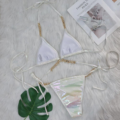 Iridescent purple and pink two-piece bikini with gold-toned crystal embellishments on a white faux fur background. - Image 34