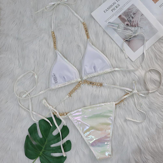 Iridescent purple and pink two-piece bikini with gold-toned crystal embellishments on a white faux fur background. - Image 34
