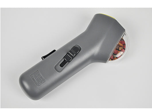 Dog Treat Launcher in retail packaging, a gray handheld device for dispensing snacks during training or playtime. - Image 4