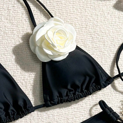 Black two-piece bikini with white 3D flower embellishments on the triangle top and tie-side bottom. - Image 3