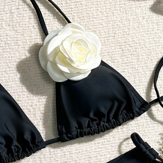 Black two-piece bikini with white 3D flower embellishments on the triangle top and tie-side bottom. - Image 3