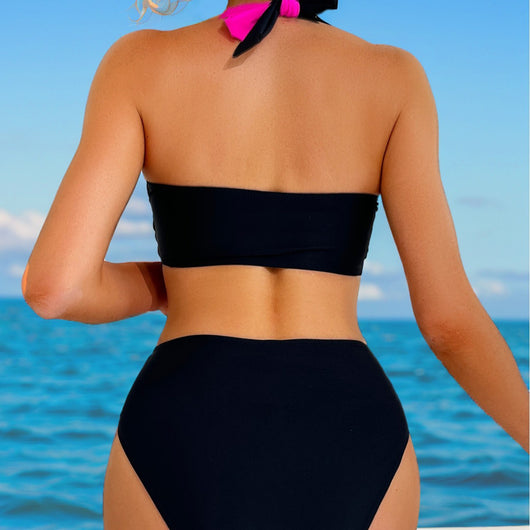 Black and white color-block halter bikini with high-waisted bottoms, modeled by a woman holding a straw hat. - Image 3